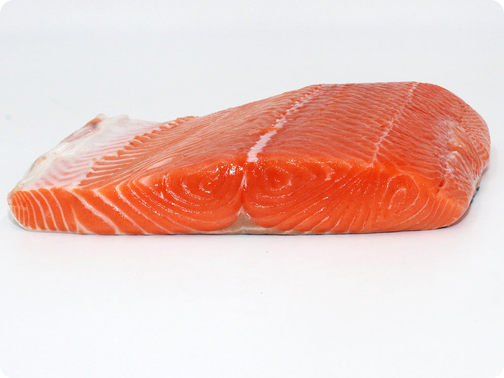 fresh wild king salmon fillet on cutting board