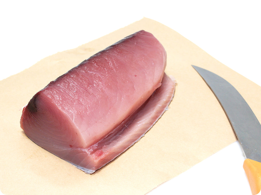 fresh tombo tuna loin with knife