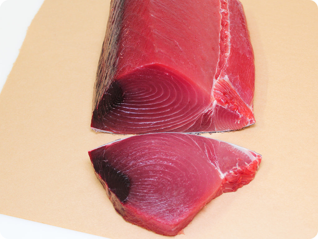 fresh ahi tuna loin with a steak cut from it