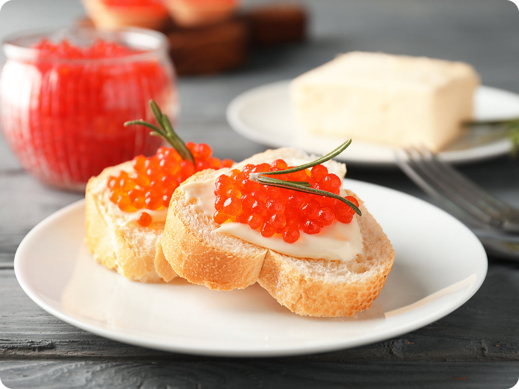 Ikura Salmon Caviar on French baguette with butter.