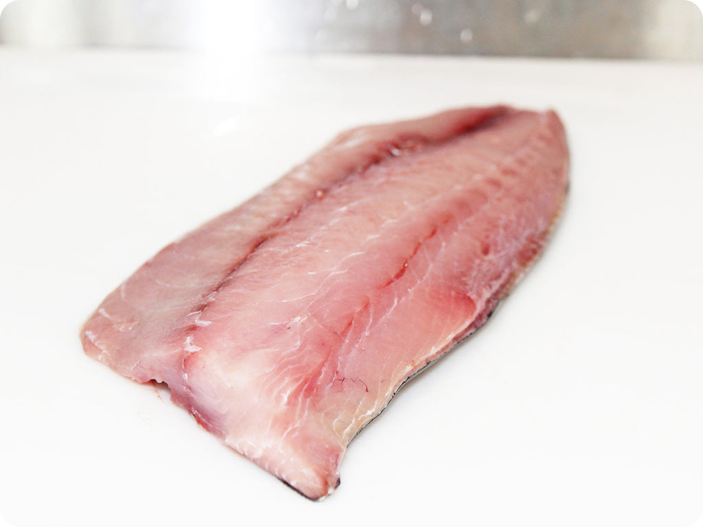 wild and fresh yellowtail amberjack on cutting board