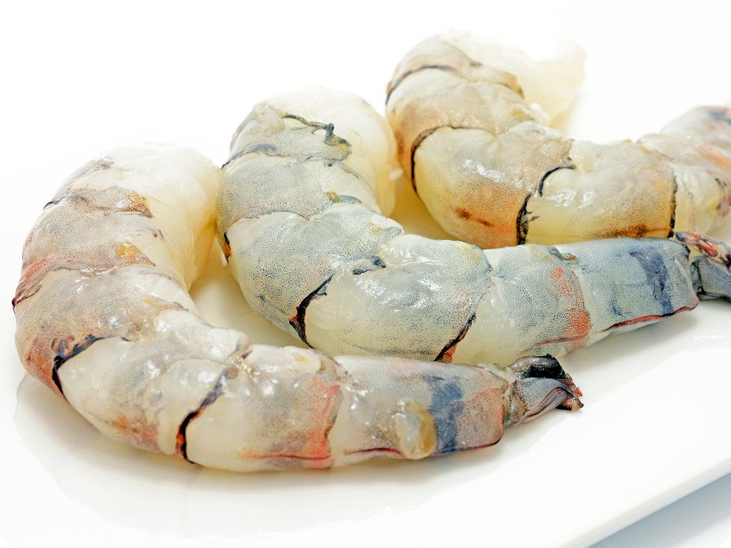 Plump, white shrimp with head and shells removed. The Black Tiger Prawns have a beautiful black speckling when removed from their shell.