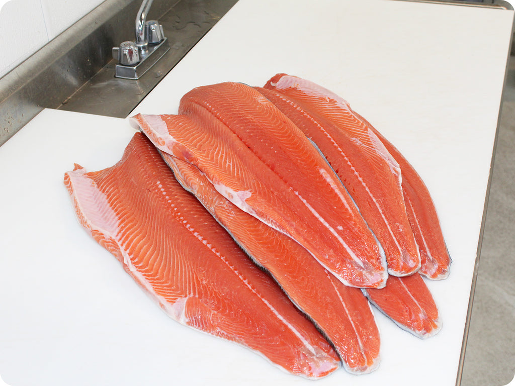 bright red wild coho fillet on cutting board