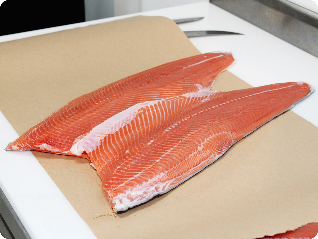 bright red fresh wild coho fillet on cutting board