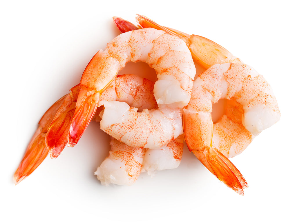 Plump, white shrimp with head and shell removed. The cooked Tiger Shrimp have a beautiful orange speckling when removed from their red shell.