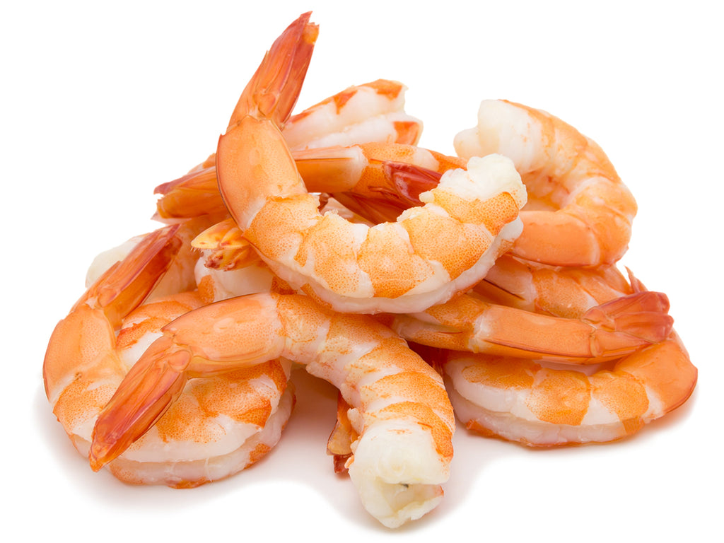 Plump, white shrimp with head shells removed. The cooked Tiger Shrimp have a beautiful orange speckling when removed from their red shell.
