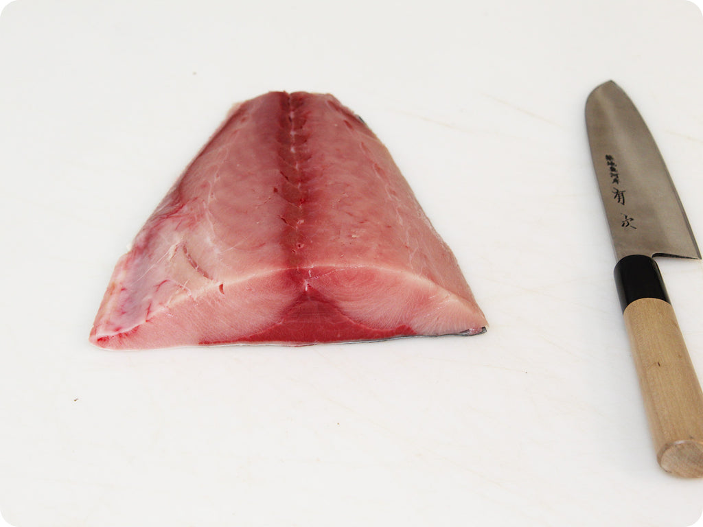 hamachi fillet on cutting board with knife