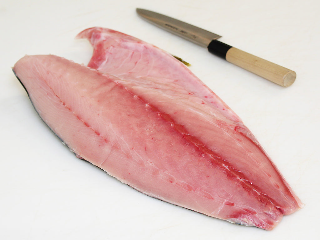hamachi fillet on cutting board with knife