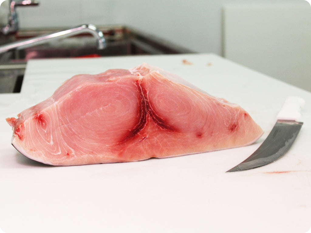 ultra-fresh swordfish loin on cutting board