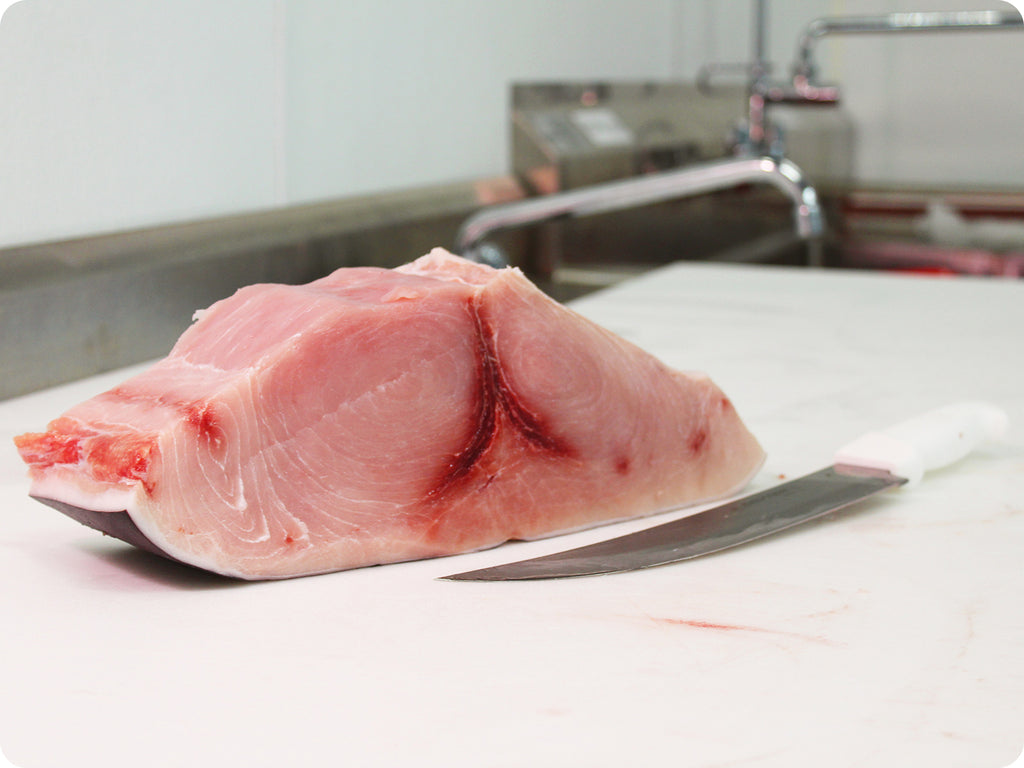 ultra-fresh swordfish loin on cutting board